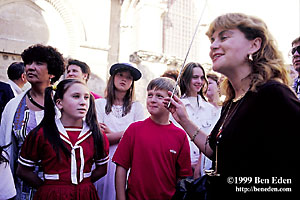 A Russian tourist guide yields an extended radio antenna while she addresses her mostly teenage group in front of the Church of The Holy Sepulchre   in the Old Town, Jerusalem, Israel