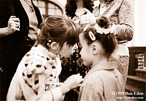 Two Jewish girls hold a confidential conversation during a Chanukah (Hanukah) Party for children in the Prague Jewish Community.