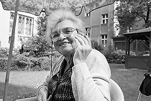 Leopoldina Natanova, a Czech Jewish Holocaust survivor, smokes a cigarette with a smile outdoors in the garden of Prague's Charles Jordan retirement home.