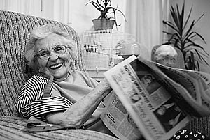 Vlastimila Zingerova, a Czech Jewish Holocaust survivor, laughs into the camera over her daily newspaper in the communal room of the Charles Jordan retirement home in Prague, Czech Republic.