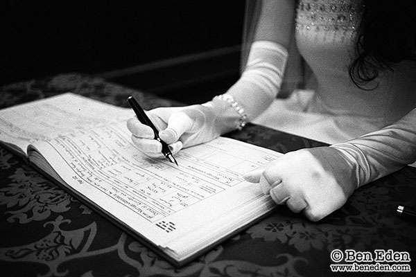 Bride signs the wedding register in London, UK