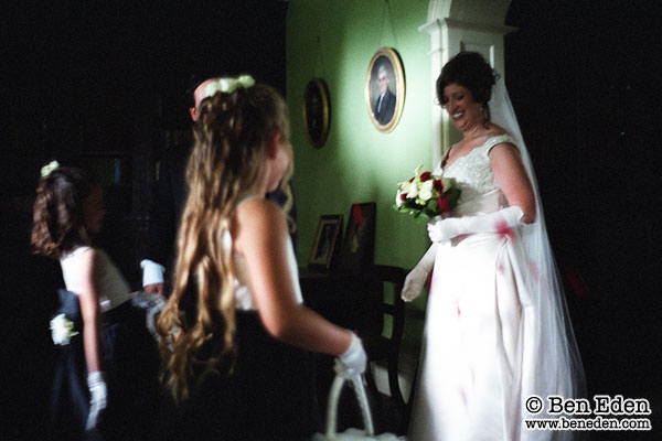 Bride standing, watched by Bridesmaids