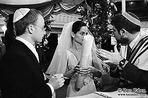 Photographs of bride and groom signing the Ketubah